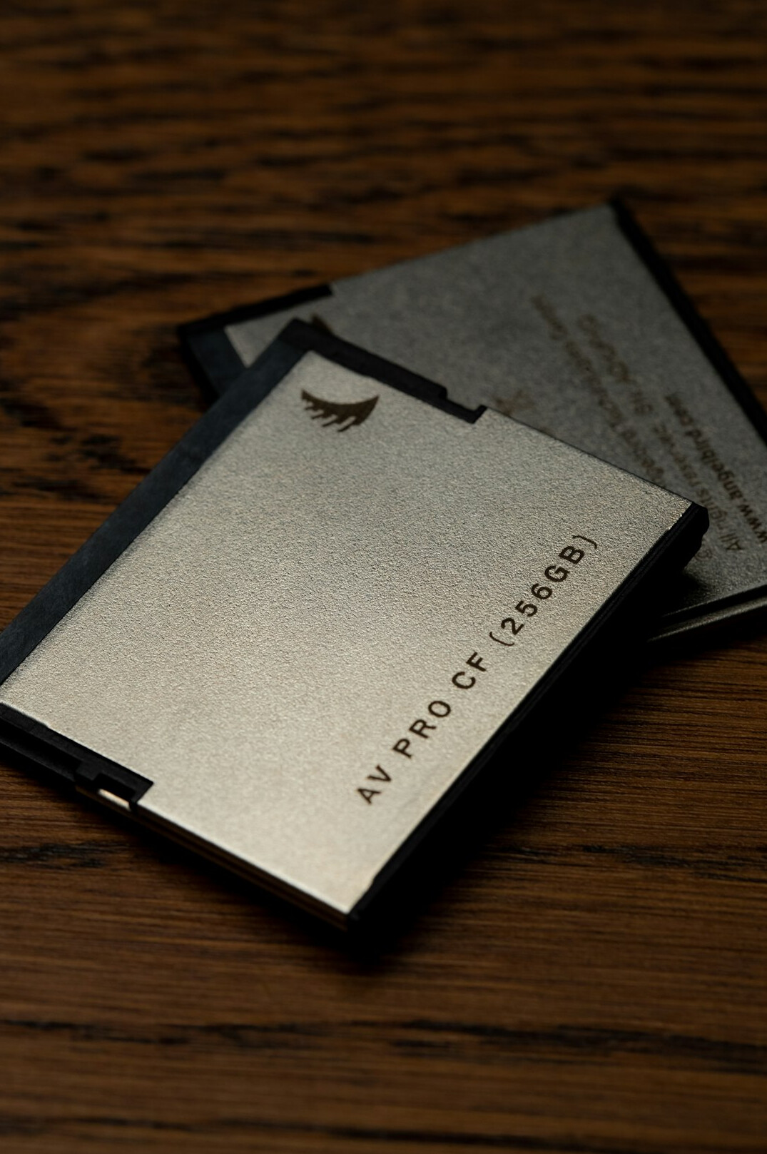 Case folders with typed labels stacked on a wooden table with a brass paperclip