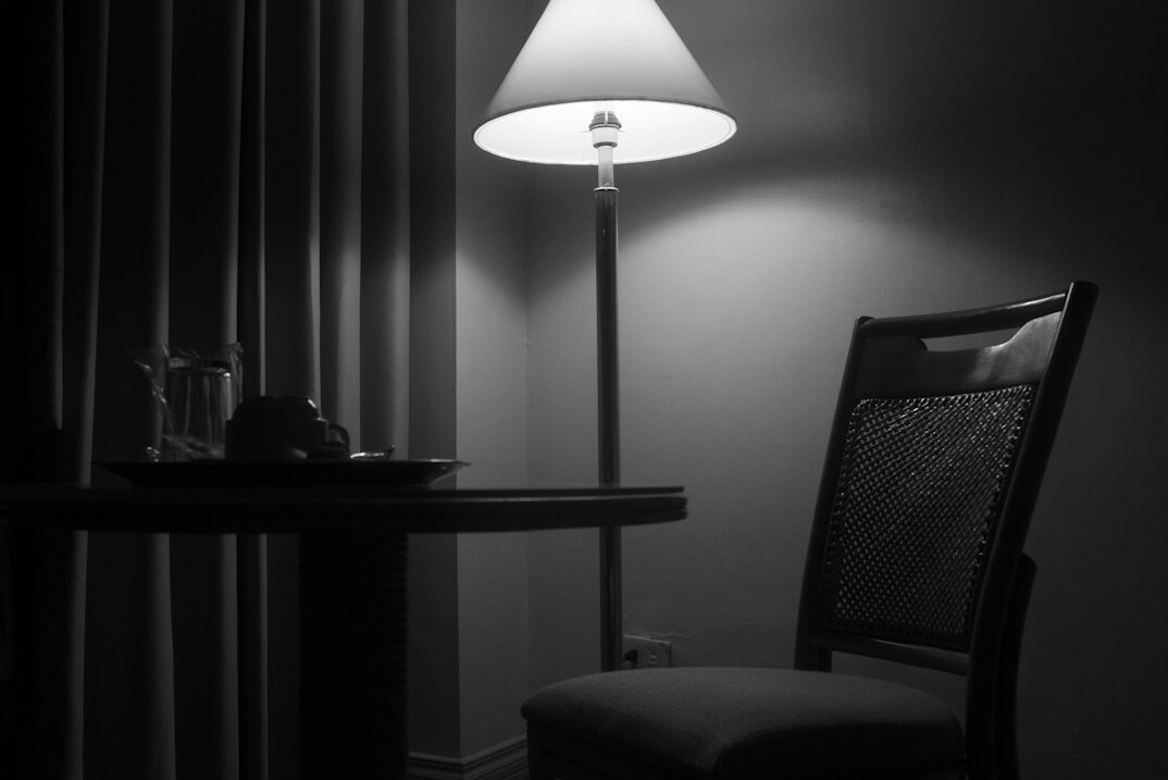 Writing desk with fountain pen, notebook and a green banker lamp