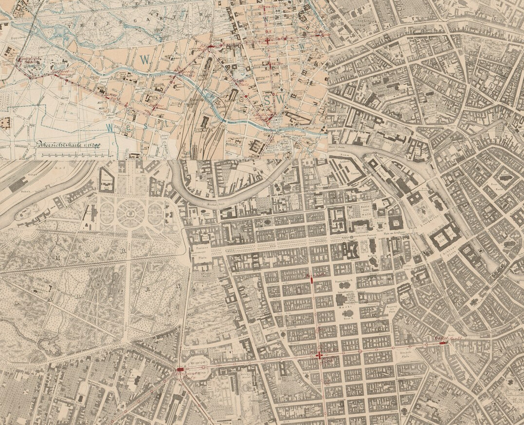 Vintage city map of a German town spread on a table with a compass and pencil